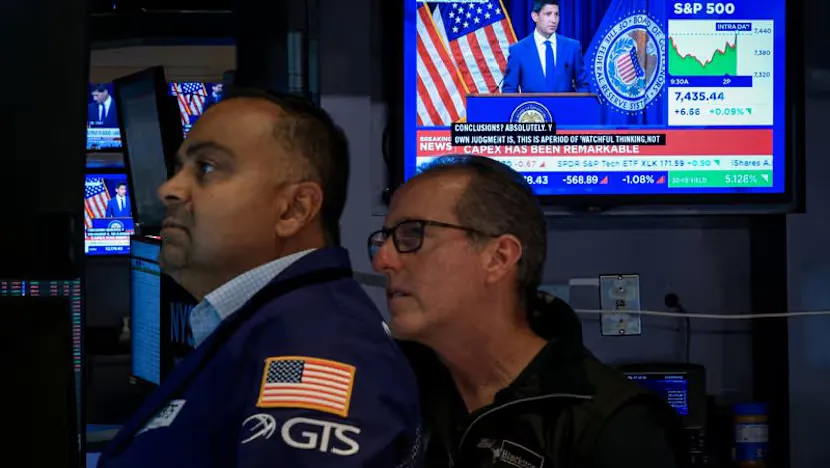 Financial screens displaying stock charts and software sector data