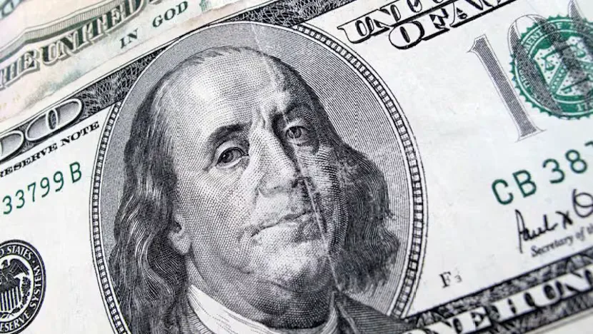 U.S. and Australian banknotes beside a foreign exchange rate display