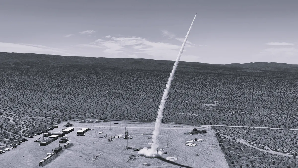 Illustration of a missile interceptor beside an aerospace manufacturing facility