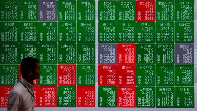 Financial market screens displaying Asian stock benchmarks and commodity prices