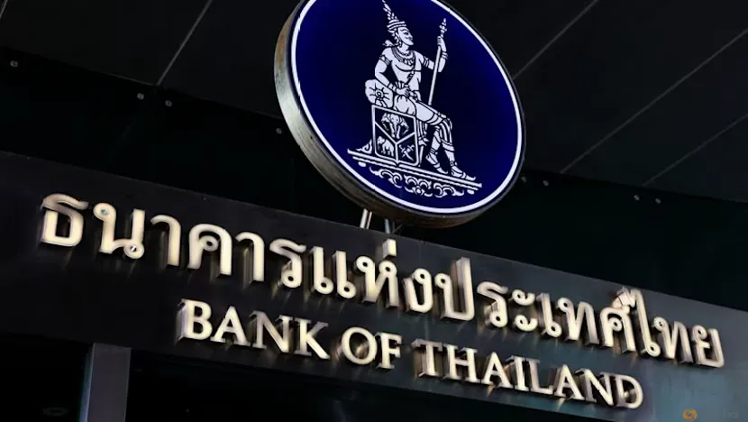 Thai baht banknotes beside a chart illustrating interest rates