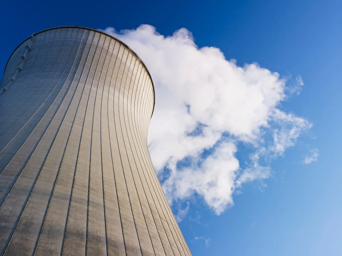 Nuclear power plant buildings beside electricity transmission lines