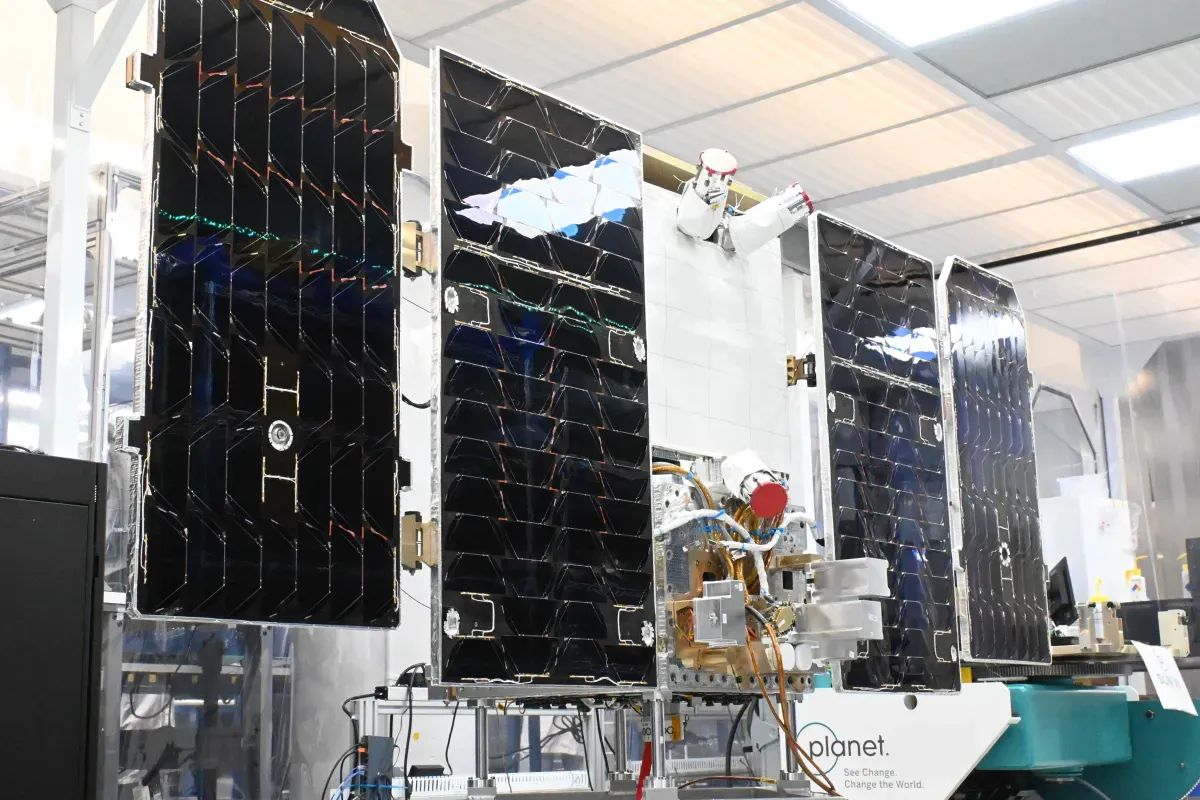 Illustration of a satellite with solar panels orbiting Earth