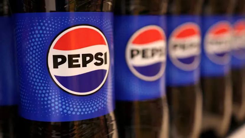 Packaged snacks and bottled beverages on supermarket shelves