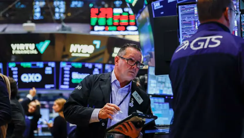 Financial screens displaying stock indexes, bond yields and oil prices