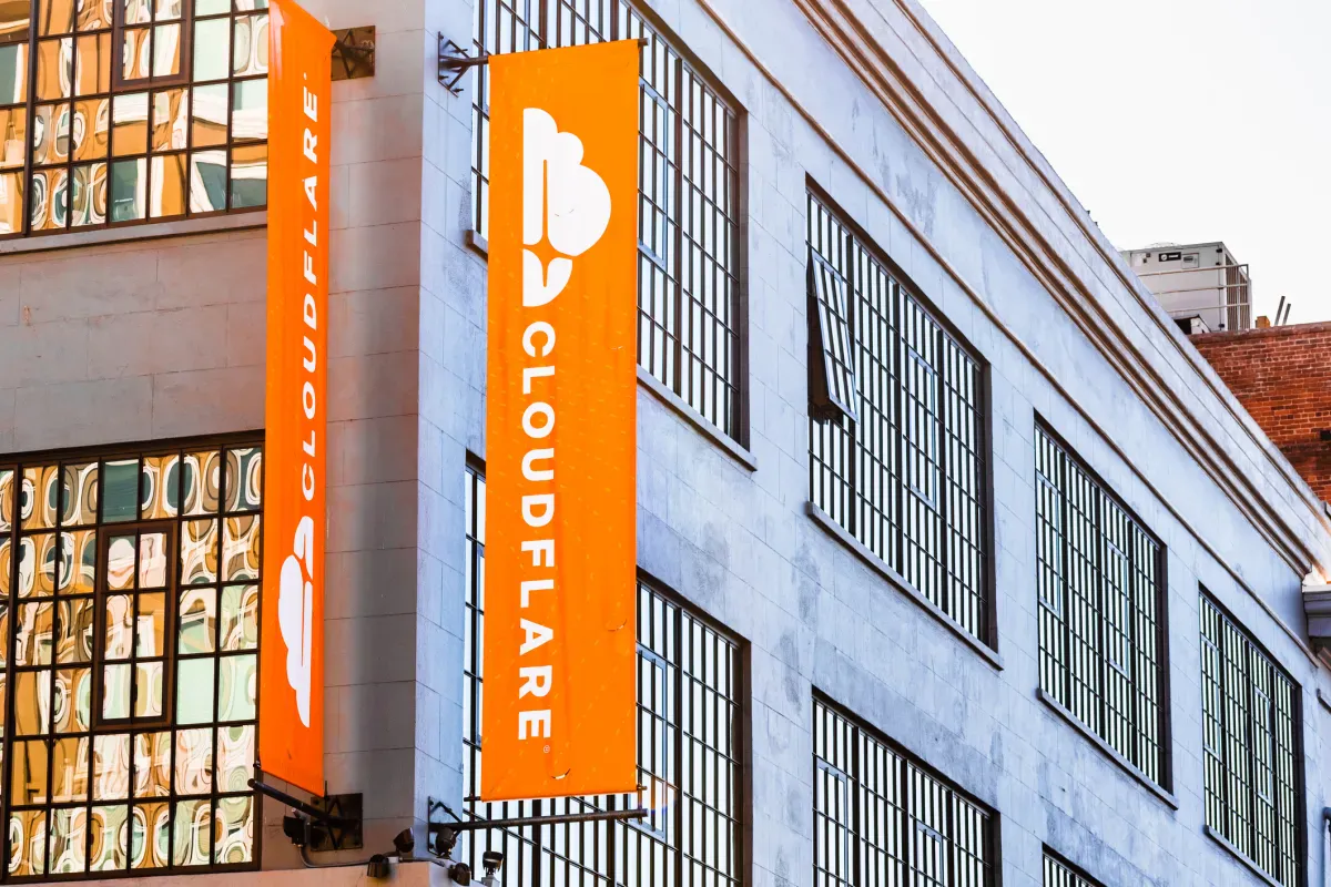 Computer screen displaying software code alongside cloud infrastructure diagrams