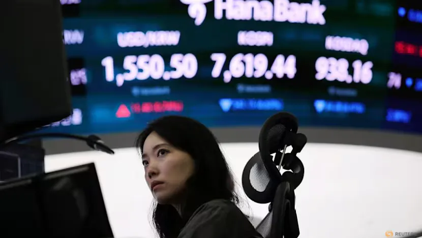 Stock market screens displaying Asian equity indices and semiconductor shares